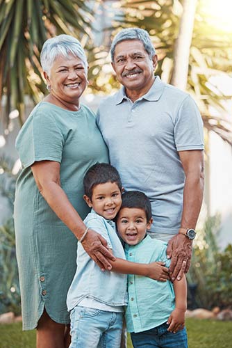 Senior couple spending time outdoors with their two grandsons