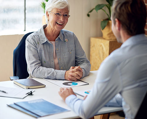 Happy senior woman meeting with her financial advisor to talk about annuities